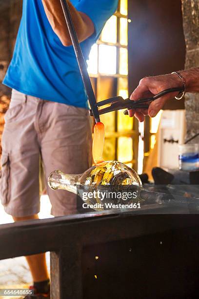 men working with molten glass in a glass factory - glass blowing stock pictures, royalty-free photos & images