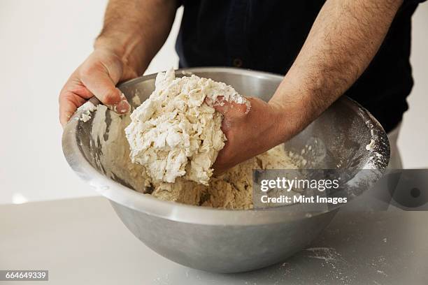 https://media.gettyimages.com/id/664649339/photo/close-up-of-a-baker-kneading-bread-dough-in-a-metal-mixing-bowl.jpg?s=612x612&w=gi&k=20&c=yciQW-Ct2jOq6X5uA46OgjcjlLbjE2JmBhPgl28hb9I=