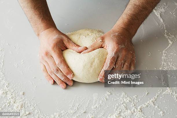 close up of a baker kneading and shaping bread dough into a ball. - kneading stock pictures, royalty-free photos & images