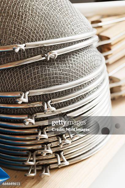 close up of a stack of metal sieves. - sieve stock pictures, royalty-free photos & images