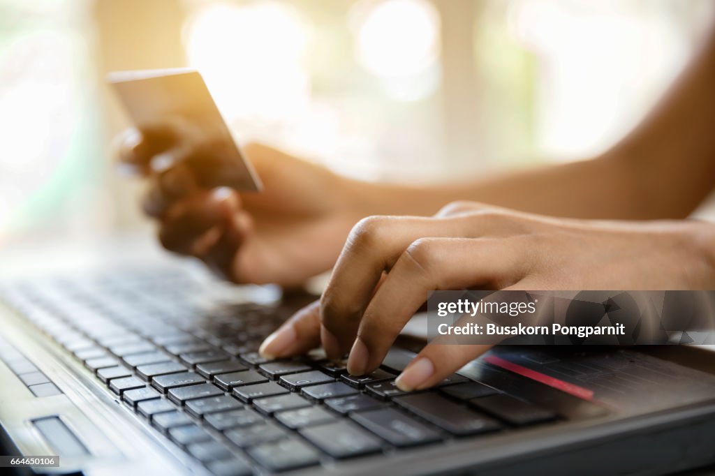 Hands holding credit card and-using laptop online shopping