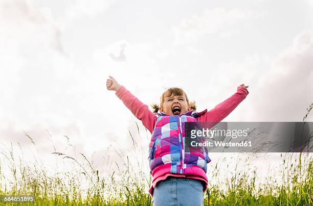 little girl screaming out loud in nature - child arms raised stock pictures, royalty-free photos & images