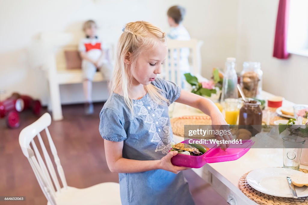 Girl packing lunch box