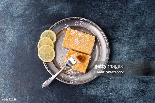 lemon cake with icing sugar on plate - lemon slice stock pictures, royalty-free photos & images