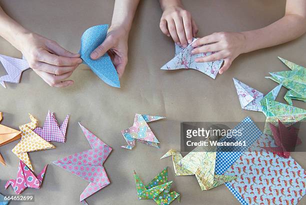 hands doing origami - origami stock pictures, royalty-free photos & images