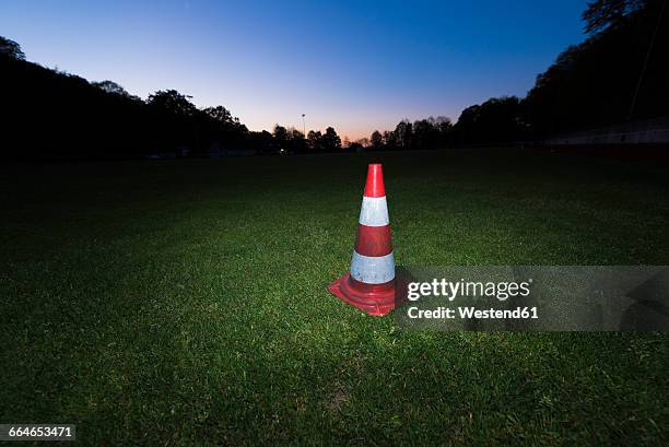 germany, traffic warning cone on a soccer field - blue hour stock pictures, royalty-free photos & images