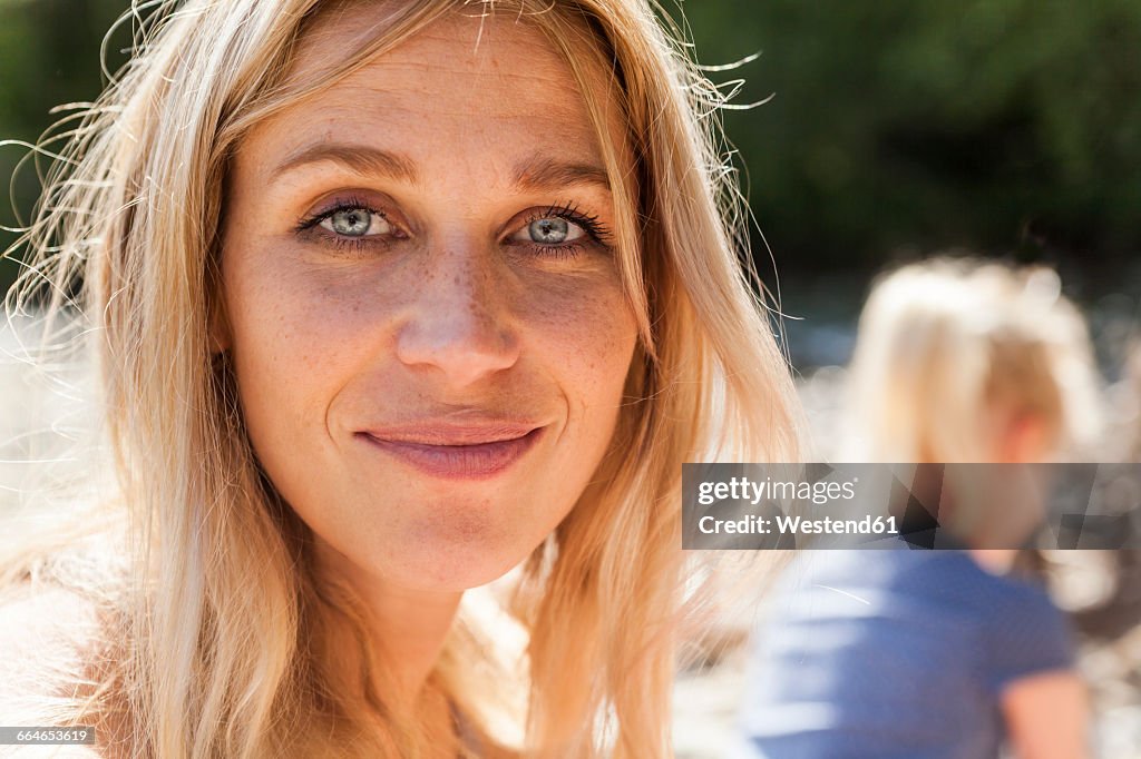 Portrait of smiling blond woman with freckles