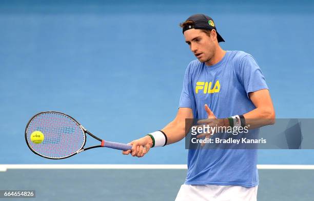 John Isner of the USA plays a shot during practice ahead of the Davis Cup World Group Quarterfinal match between Australia and the USA at Pat Rafter...