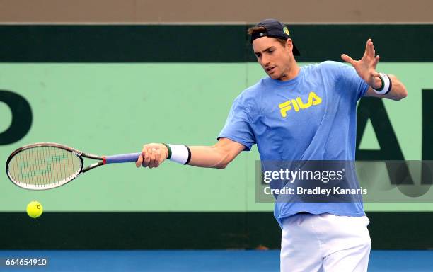 John Isner of the USA plays a forehand during practice ahead of the Davis Cup World Group Quarterfinal match between Australia and the USA at Pat...