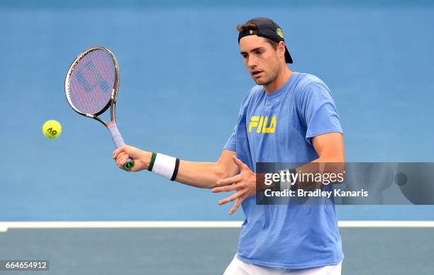 John Isner of the USA plays a shot during practice ahead of the Davis Cup World Group Quarterfinal match between Australia and the USA at Pat Rafter...