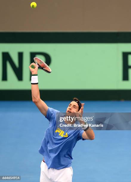 John Isner of the USA plays a shot during practice ahead of the Davis Cup World Group Quarterfinal match between Australia and the USA at Pat Rafter...