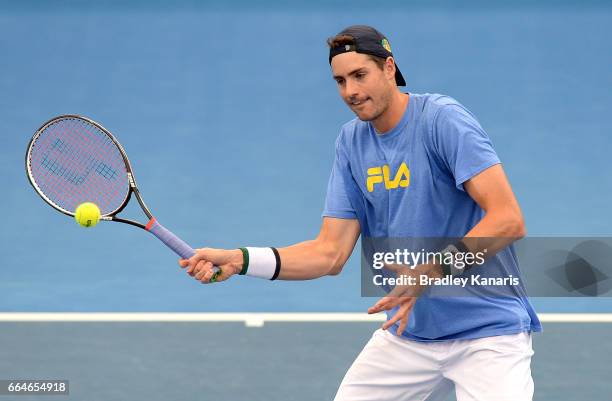 John Isner of the USA plays a shot during practice ahead of the Davis Cup World Group Quarterfinal match between Australia and the USA at Pat Rafter...