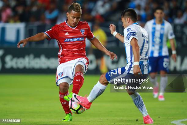 Emmanuel Garcia of Pachuca struggles for the ball with Michael David Barrios of FC Dallas during the semifinals second leg match between Pachuca and...