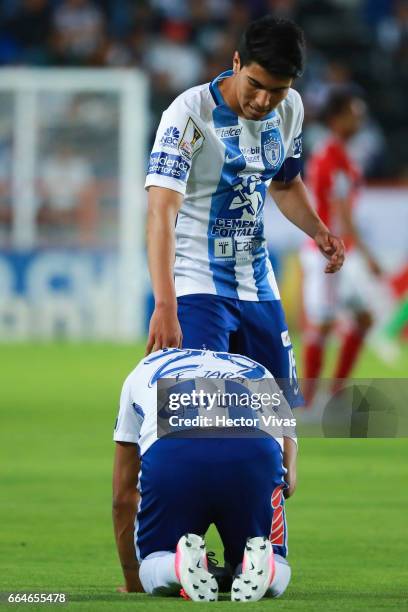 Franco Jara of Pachuca reacts in pain as teammate Erick Gutierrez tries to help him during the semifinals second leg match between Pachuca and FC...