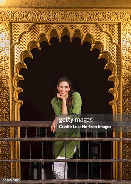 woman in ornate doorway looking at camera smiling, marrakesh, morocco - leaning on elbows stock pictures, royalty-free photos & images
