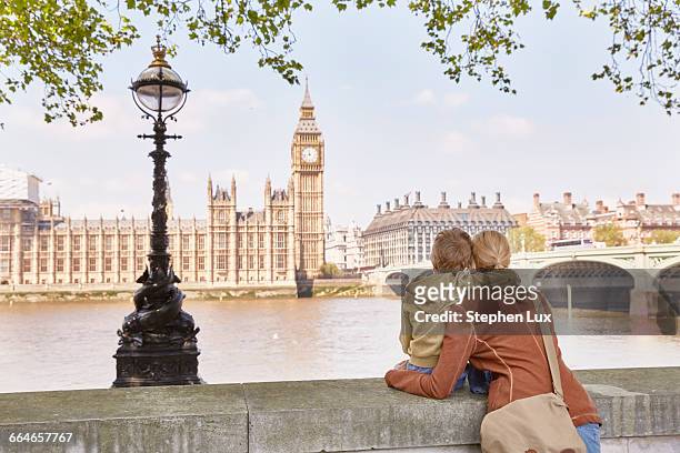 mother and son looking over river at big ben - london england stock pictures, royalty-free photos & images