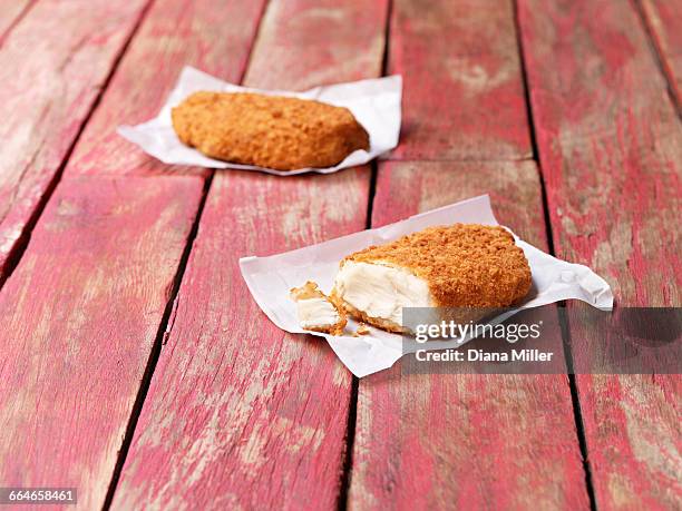 food, fish, gluten free breaded cod on painted red wooden table - papel de cera imagens e fotografias de stock
