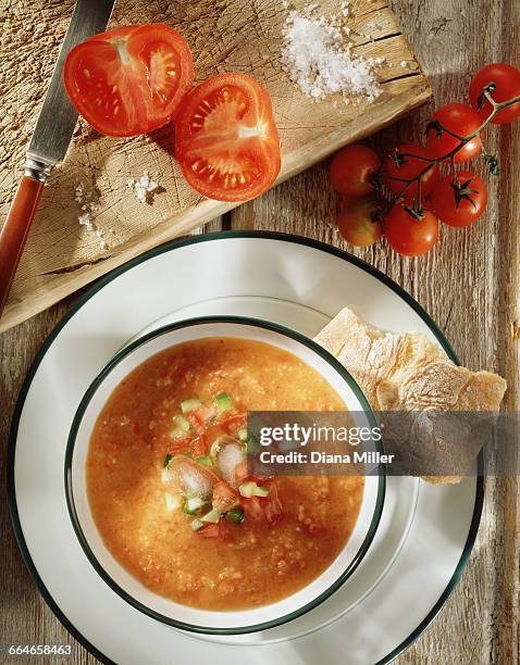 gazpacho soup with crusty ciabatta bread, freshly cut tomatoes on the vine and sea salt on rustic wooden chopping board, overhead view - gazpacho stock pictures, royalty-free photos & images