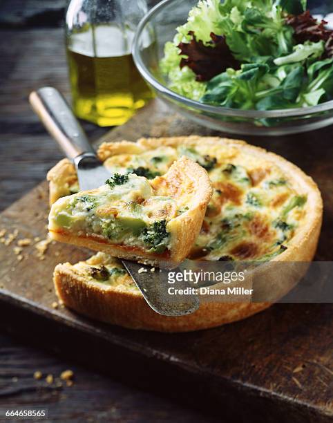 broccoli quiche and salad leaves on wooden chopping board - quiche stock pictures, royalty-free photos & images