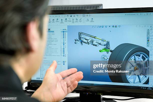 engineer works with cad design imagery in racing car factory, close up - cad designer stockfoto's en -beelden