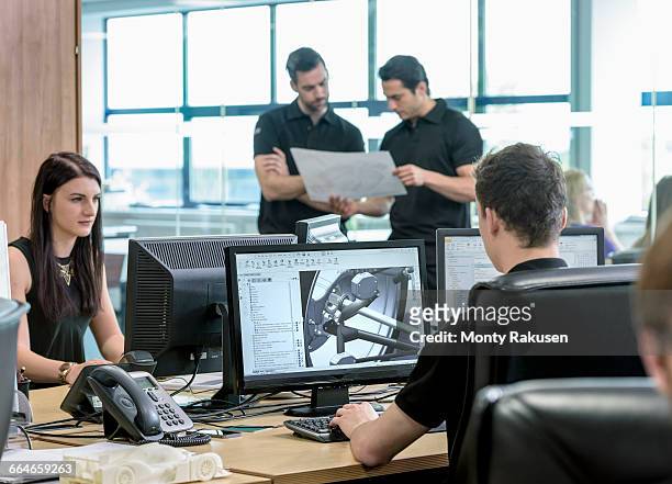 engineers work with cad design imagery in racing car factory - car engineer stock-fotos und bilder