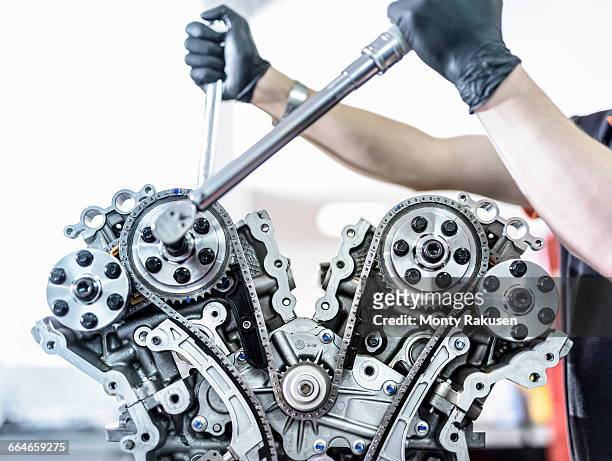 engineer working on engine in racing car factory, close up - car engine close up stock pictures, royalty-free photos & images
