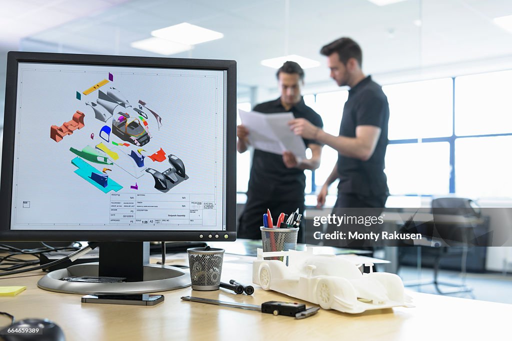 Engineers Work With Cad Design Imagery In Racing Car Factory High-Res ...