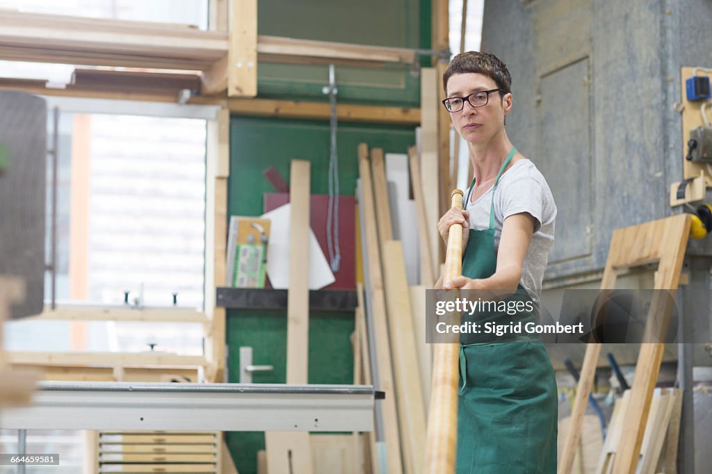 Woman in workshop checking alphorn tube