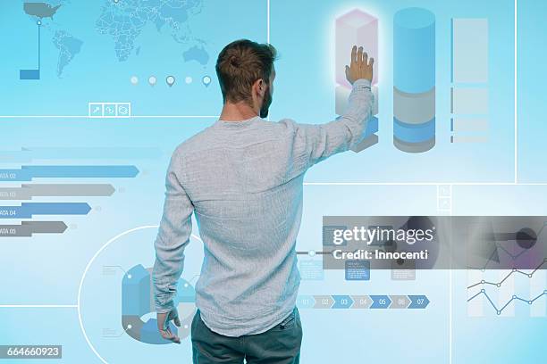 man preparing presentation on graphical screen, rear view - interactief stockfoto's en -beelden