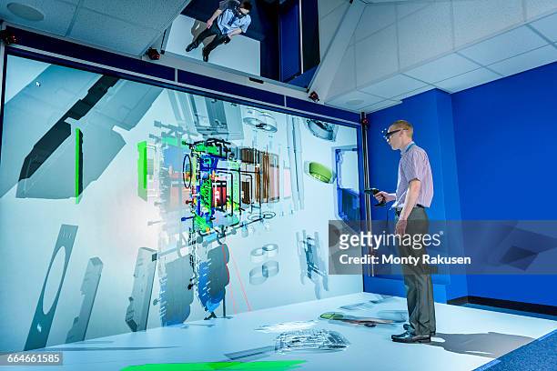 engineer looking at component parts of machine in 3d in virtual reality suite - impression 3d foto e immagini stock