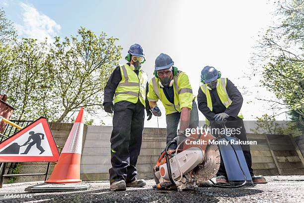 apprentice builders training with stone cutting saw in training facility - road construction safety stock pictures, royalty-free photos & images