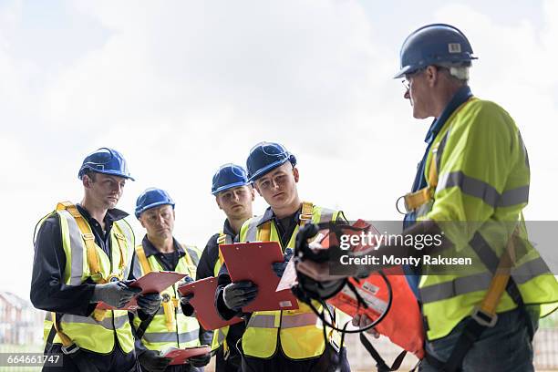 apprentice builders in presentation in training facility - safety equipment stock pictures, royalty-free photos & images