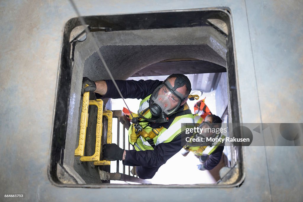 Apprentice builders training in confined space in training facility