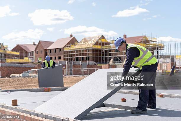 builders laying insulation on housing building site - material stock pictures, royalty-free photos & images