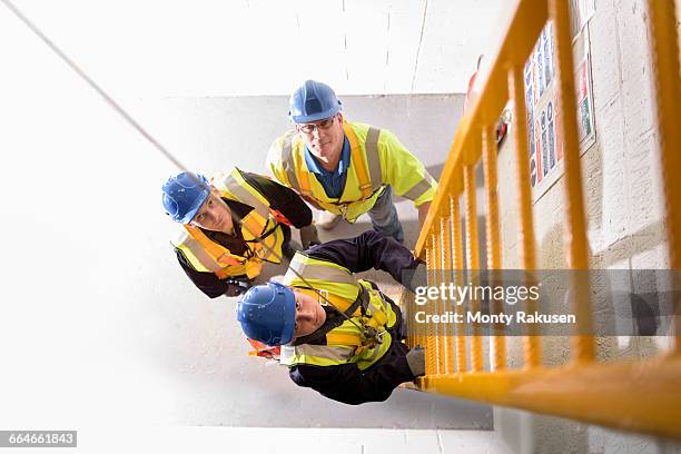 Builders Using Ladders Construction Worker On Ladder Photos and Premium High Res Pictures ...