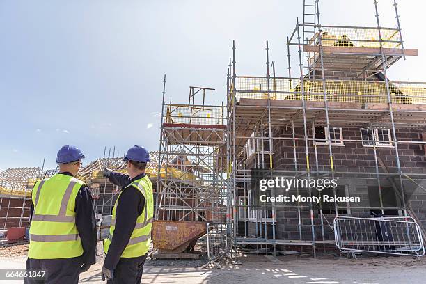 builders discussing housing development on building site - housing development bildbanksfoton och bilder