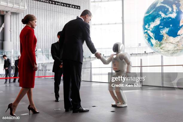 King Felipe VI shakes hands with an ASIMO robot during their visit to the National Museum of Emerging Science and Innovation on April 5, 2017 in...