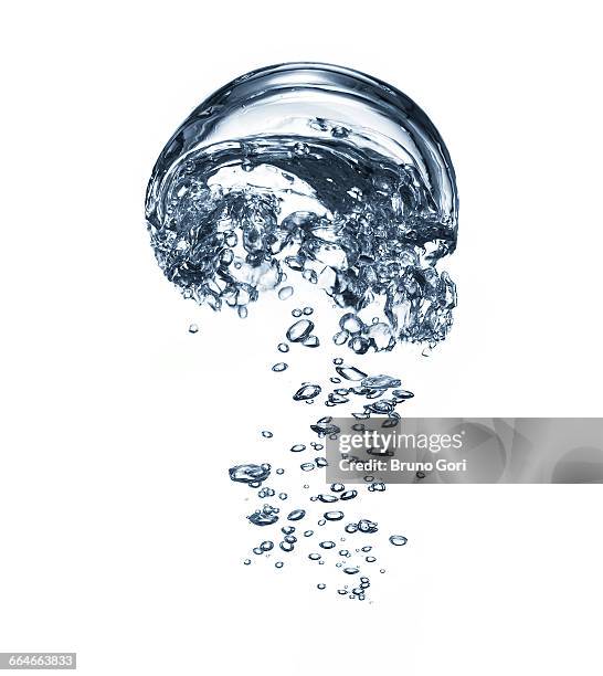 transparent liquid and bubbles rising against white background - slow motion water stock pictures, royalty-free photos & images