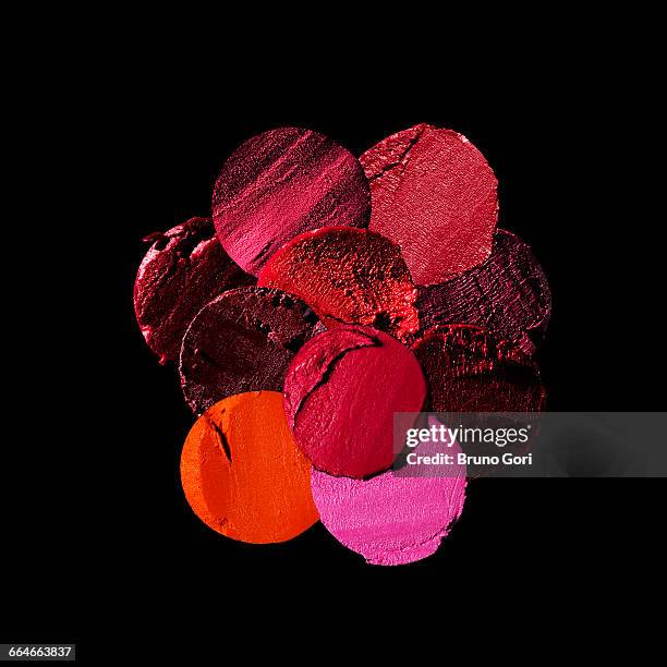 variety of circular lipstick slices against black background - lipstick stock pictures, royalty-free photos & images