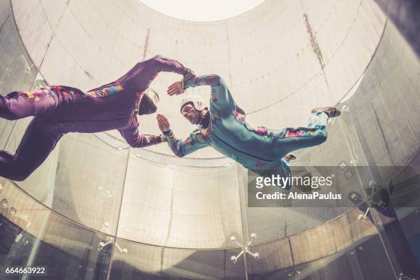 indoors skydiving -instructor teaching how to fly - freefall simulation - indoor skydive stock pictures, royalty-free photos & images
