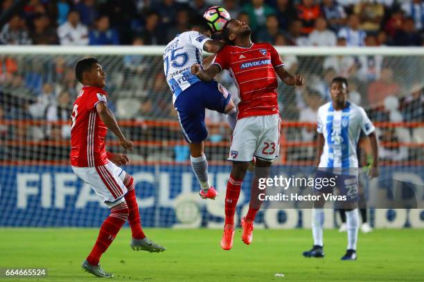 Victor Guzman of Pachuca struggles for the ball with Kellyn Acosta of FC Dallas during the semifinals second leg match between Pachuca and FC Dallas...