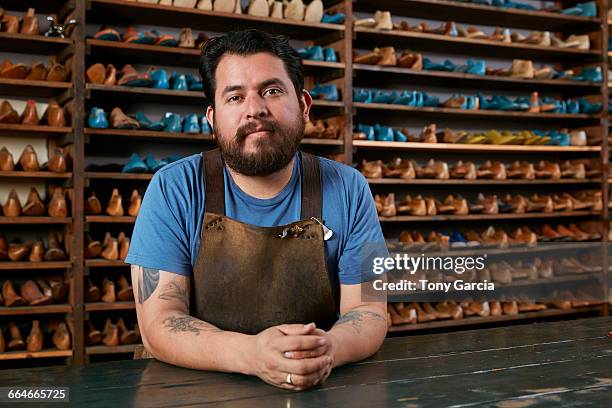 portrait of male cobbler at traditional shoe shop counter - shoe maker stock pictures, royalty-free photos & images