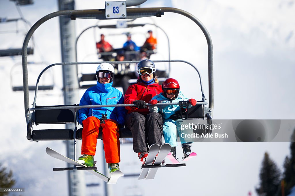 Mother and two sons on ski lift
