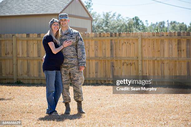 portrait of male soldier and pregnant wife at air force military base - us airforce stock pictures, royalty-free photos & images