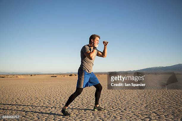 man kickbox training on dry lake bed, el mirage, california, usa - el mirage stock pictures, royalty-free photos & images