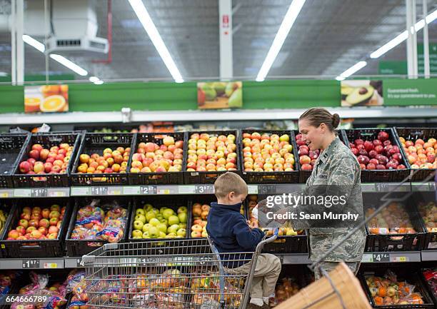 female soldier shopping with son in supermarket at air force military base - air vehicle imagens e fotografias de stock