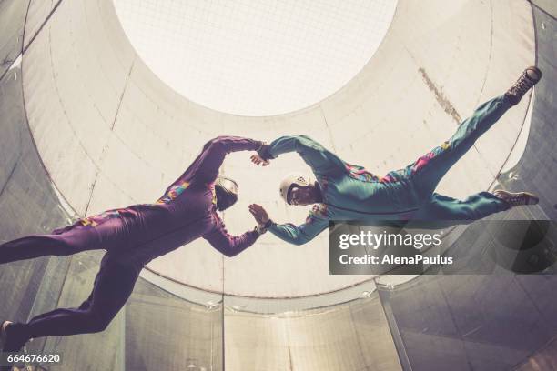 indoors skydiving -instructor teaching how to fly - freefall simulation - indoor skydive stock pictures, royalty-free photos & images