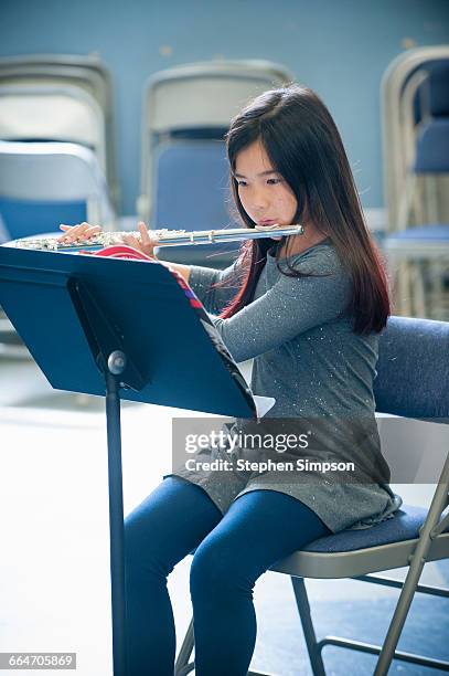 young girl practicing the flute - flauto foto e immagini stock