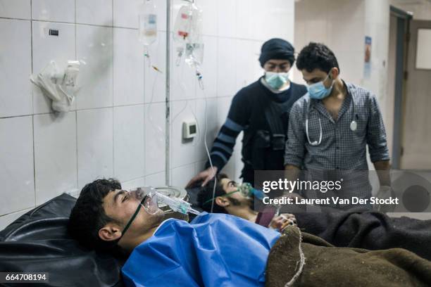 Rebel fighters from Liwa Maghawer al Ghuta is treated the day after a suspected chemical weapon attack by the Syrian Army on the frontline of Jobar,...