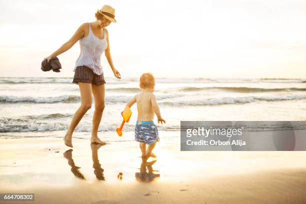 madre e hijo juegan en la playa - océano pacífico fotografías e imágenes de stock